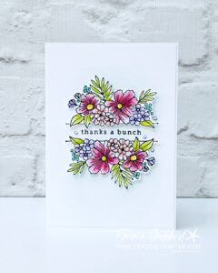 A simple white card with a focal image of flowers in the middle. These have been coloured with watercolour pencils and a wink of stella pen for some added sparkle